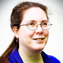 About the author: Genevieve Cogman - A white skinned woman with brown hair pulled back into a ponytail, she is wearing thin framed glasses, drop earrings and a dark blue top. She is looking up to the right, away from the camera and smiling.