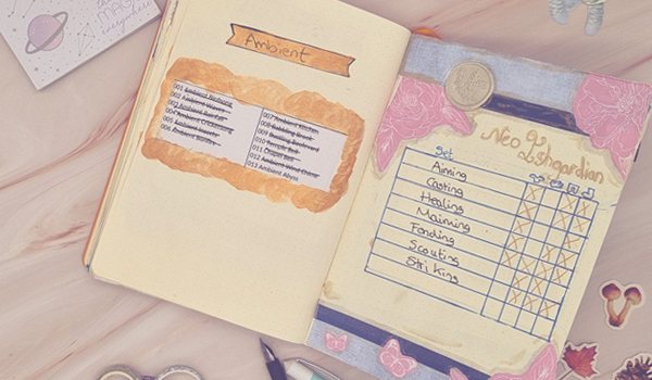 March 2024 Wrap-Up - Neo Ishgardian gear spread in my Final Fantasy XIV bullet journal - A bullet journal is laid open on a pale pink marble background. The journal shows two pages. On the left is printed list of orchestra rolls adorned with gold paint. Opposite on the right is a page decorated with blue paper and pink cut out butterflies and flowers with a handwritten list of Neo-Ishgardian gear from Final Fantasy XIV. Around the journal are various stationery items. To the left, a small square post-it note pad with celestial and planetary designs and a printed message 'there is magic everywhere'. Above the journal, a small purple rectangular post-it note pad has a handwritten message that reads '#jgbbujo' in dark blue in. To the right of this are two washi tapes, a dark one with a smaller white one leaning against it. On the right side of the journal, there are three stickers; a red leaf, a two-headed brown mushroom, and a pine cone. Below the journal, there is a trio of washi tapes piled together and a teal and white fountain pen unlidded. The lid is sitting next to it.